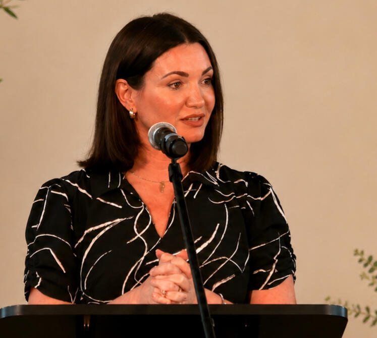 Lauren Bear Hamilton speaks at podium